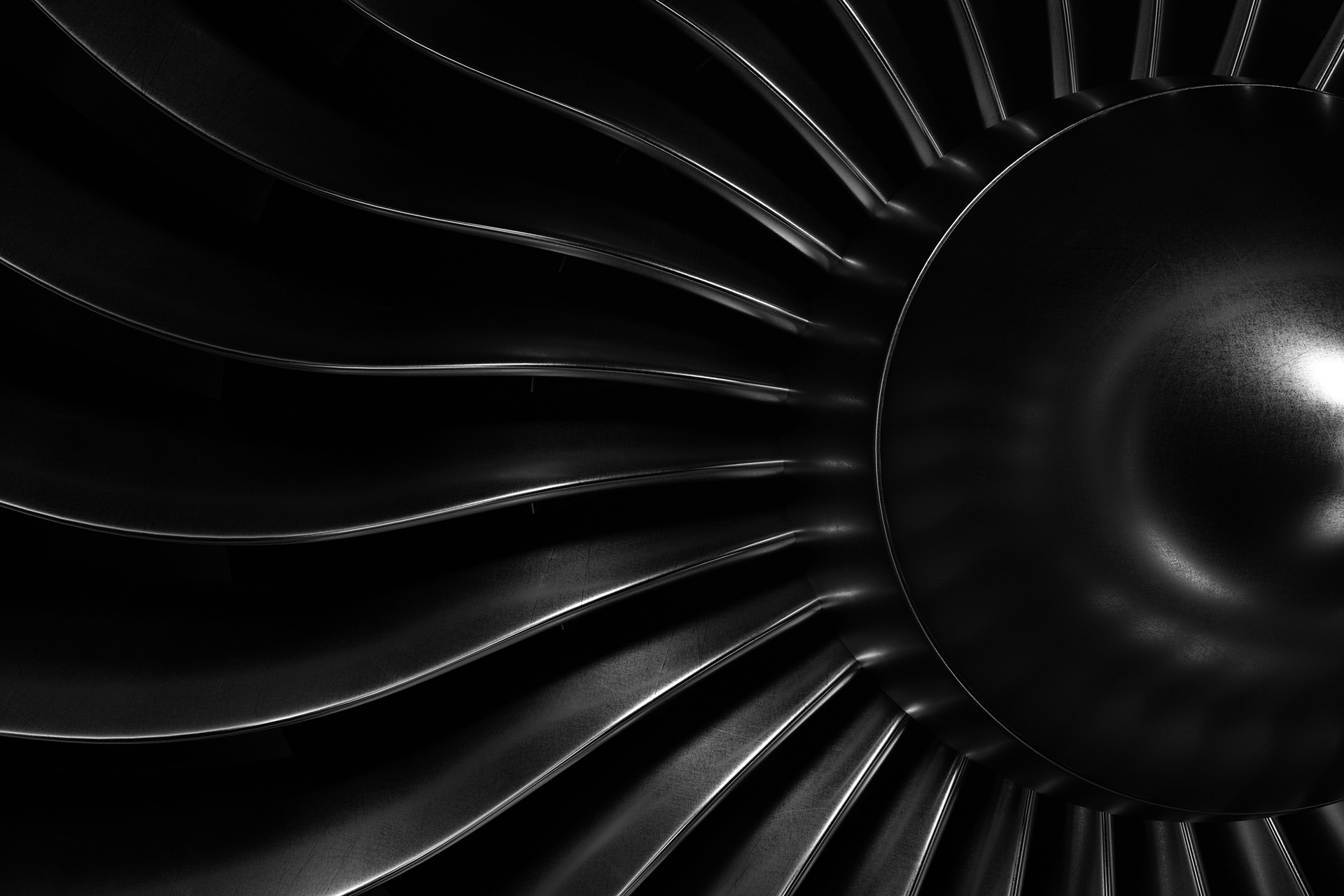 A black-and-white closeup of the blades of an airplane's turbofan engine