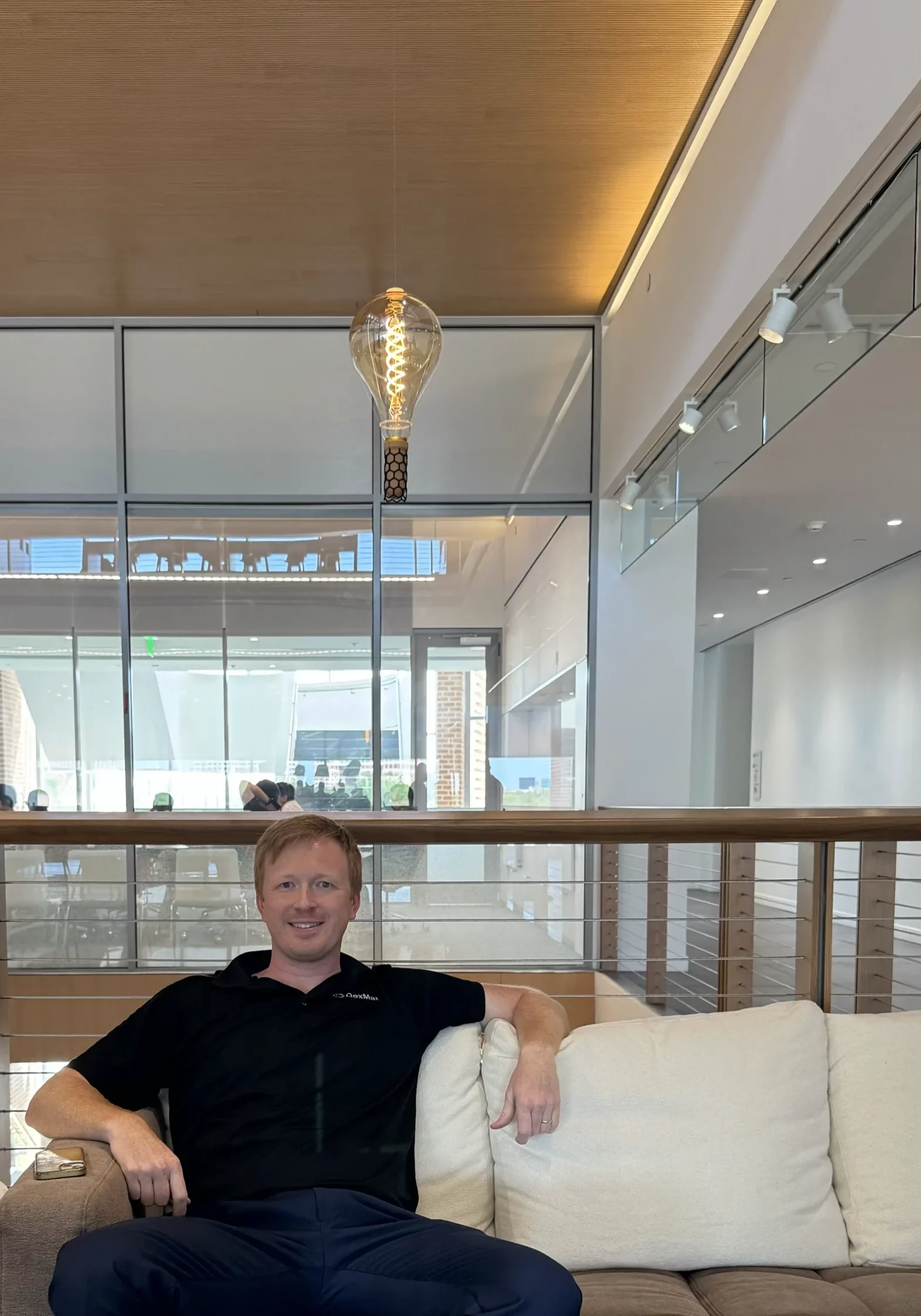 richard-smalley-galvorn-lightbulb-dmitri DexMat Co-Founder & CTO, Dmitri Tsentalovich, PhD, sitting on Richard Smalley's couch with a lightbulb simultanously suspended and powered by Galvorn above him.